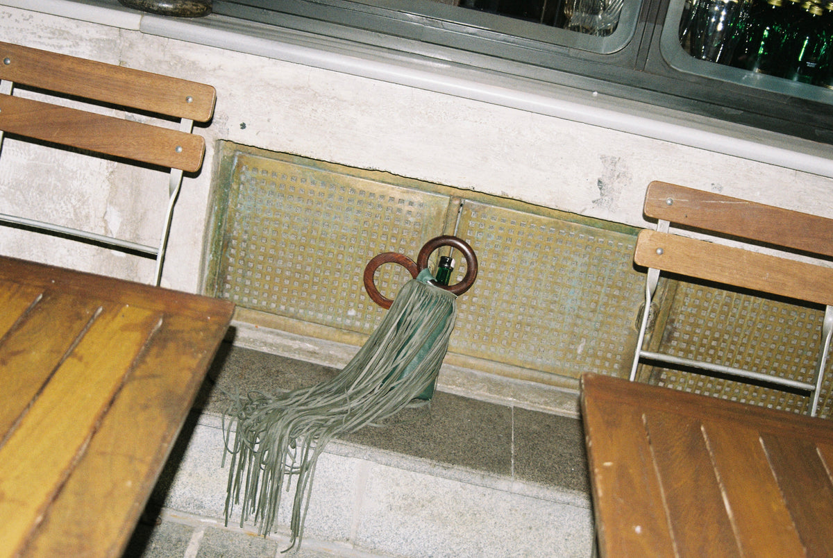 Üzüm wine bag hanging from a café chair
