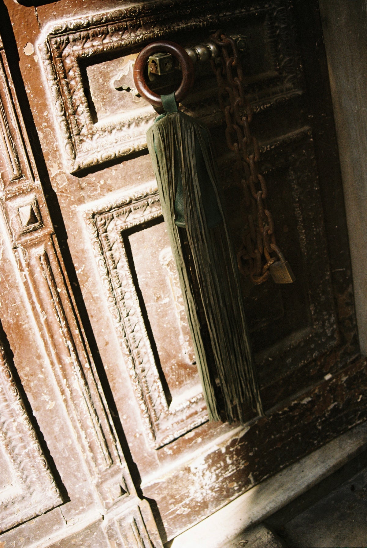 Üzüm wine bag hanging from an old wooden door